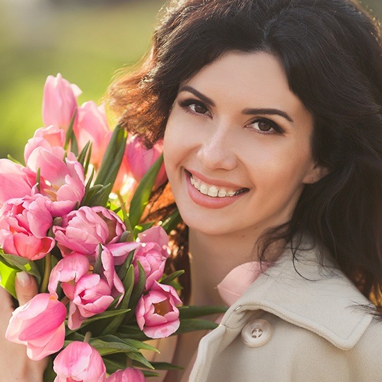 woman with clear and ceramic braces smiling