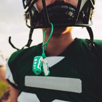 Mouthguard hanging from football helmet