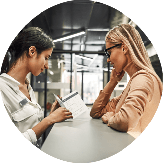 Dental patient and team member looking at dental insurance forms