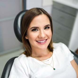 Woman smiling after Invisalign treatment in Worcester