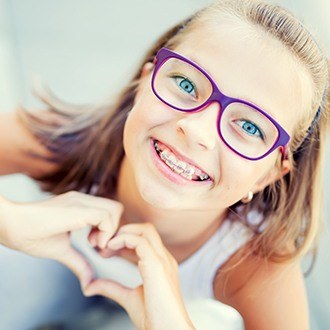 Smiling preteen girl with braces outdoors