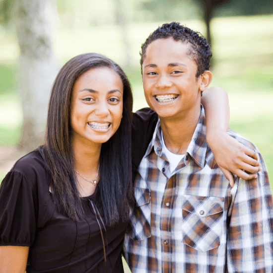 Smiling teen boy and girl with braces