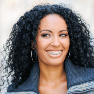 Woman with clear and ceramic bracket and wire braces