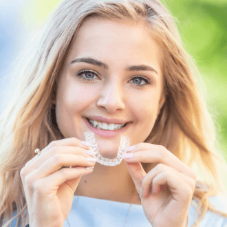 Woman placing Invisalign tray