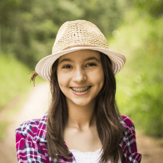 Teen girl with braces smiling outdoors